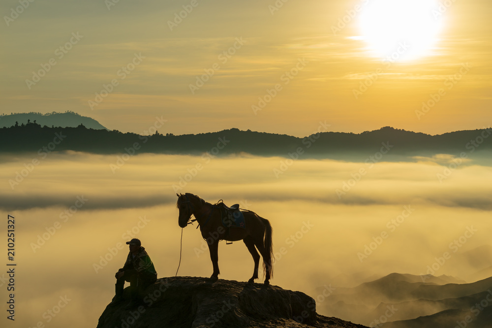 Fototapeta premium BROMO, INDONESIA - 16th APRIL 2018; Unidentified local people or Bromo Horseman at the mountainside of Mount Bromo, Semeru, Tengger National Park, East Java of Indonesia.
