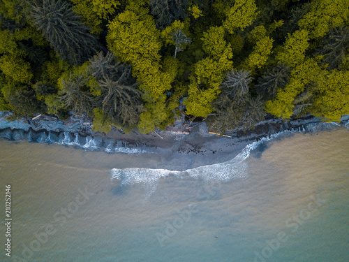 Fototapeta Naklejka Na Ścianę i Meble -  Aerial Over A Remote Pacific Northwest Beach With Waves Crashing
