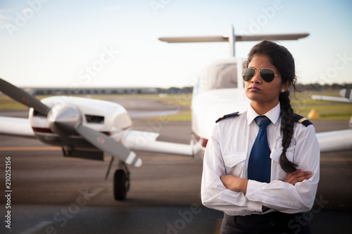 Valokuvatapetti Female Pilot Standing in Front of Her Plane