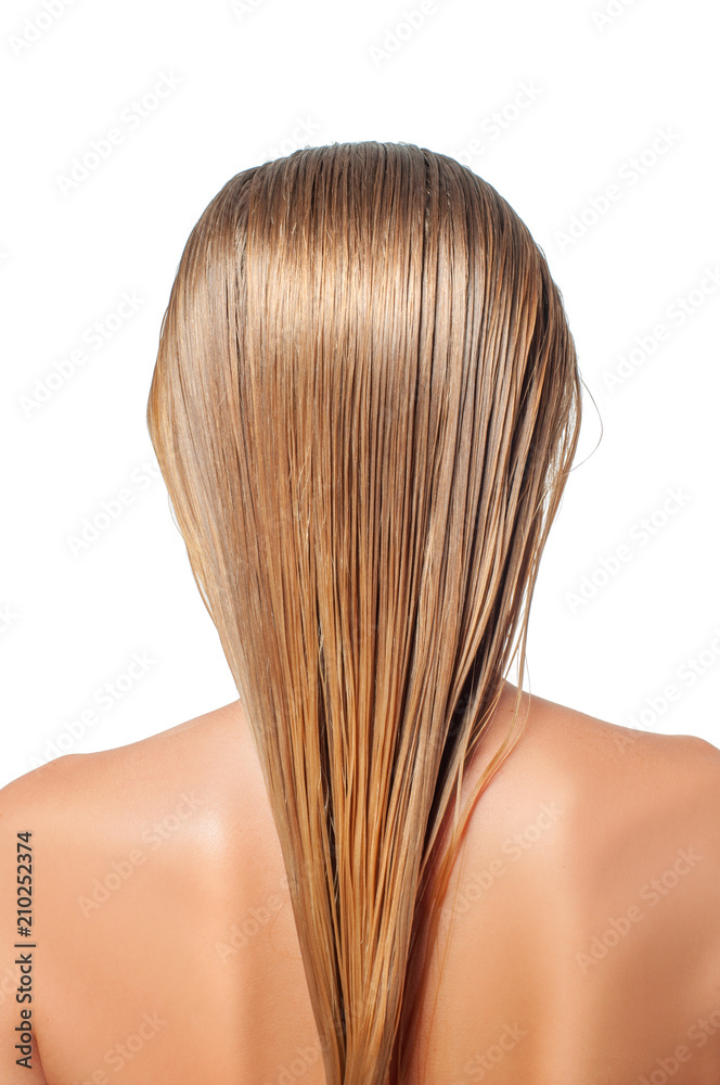 Naklejka premium Blond woman with long wet hair is applying hair conditioner