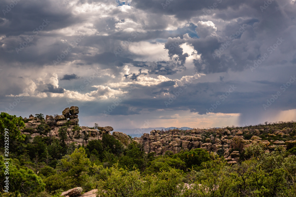 Hoodoos watch while monsoon storms swirl in the valley below at Chiricahua National Monument in southern Arizona.