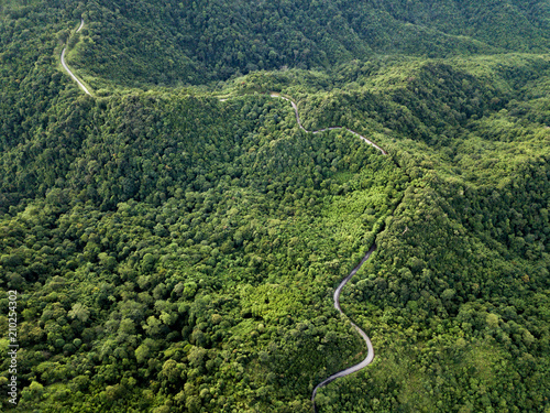 Top view beautiful rural road on the deep forest mountain. Amazing nature landscape. 