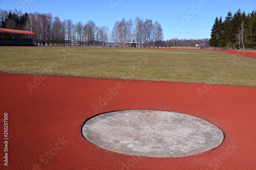 Empty sector of discus throwers in province stadium photo