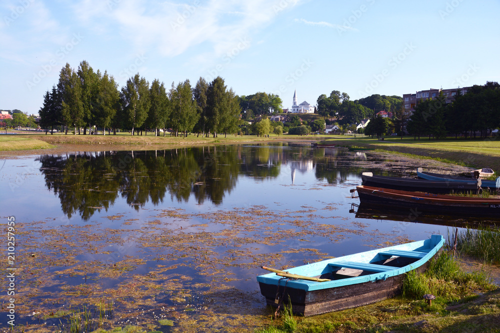 Landscape with pond and old boats Landscape with pond and old boats