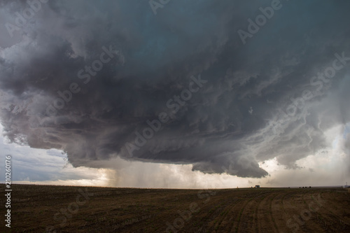 A supercell thunderstorm develops a wall cloud and begins to rotate over the plains of eastern Colorado.