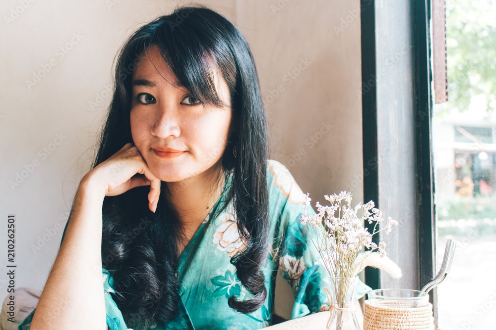 Beautiful Asian woman sitting in the cafe. Beautiful Asian woman sitting in the cafe.