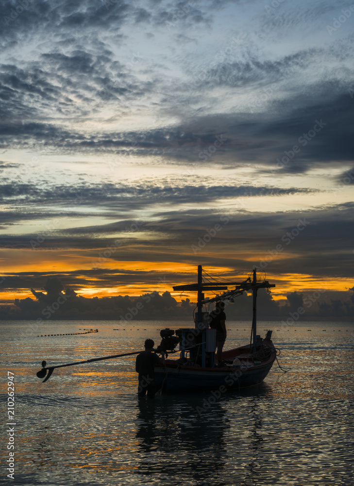 A fishing boat is ready to work in dawn
