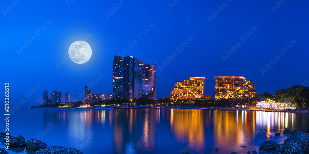 Panorama Colorful light Pattaya city in night time with full moon
