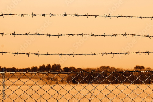 Barbed wire detention center at countryside and background sepia color style cowboy