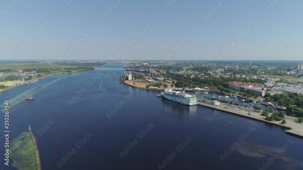 Slowmotion Riga City Daugava river and ferry drone Flight near Old town with buildings and cars Slowmotion Riga City Daugava river and ferry drone Flight near Old town with buildings and cars