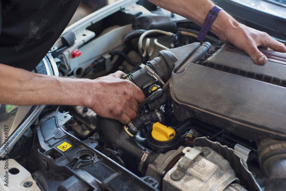 Auto mechanic repairing car. Selective focus. Auto mechanic repairing car. Selective focus.