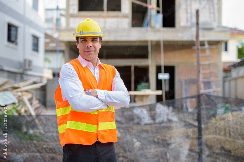 Handsome Persian man construction worker at the construction sit Handsome Persian man construction worker at the construction sit