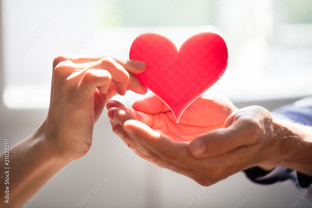 Woman Giving Heart On Man's Hand Woman Giving Heart On Man's Hand