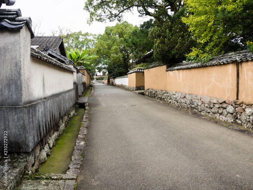 Pedestrian street with plaster walls in historic downtown Kitsuki - Oita prefecture, Japan