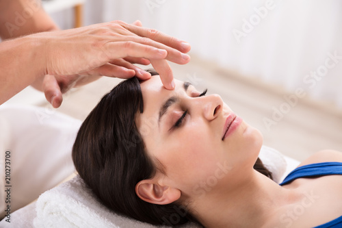 Calm Woman Receiving Reiki Treatment