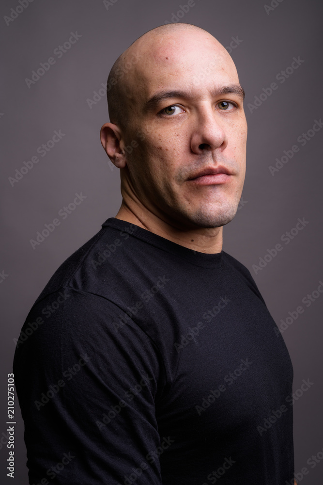 Fototapeta premium Handsome bald man against gray background
