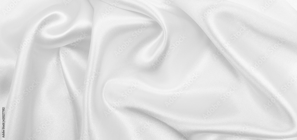 Smooth elegant white silk or satin luxury cloth texture as wedding background. Luxurious background design