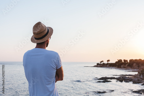 Young man enjoying sunset on a cliff at a seaside © marjan4782
