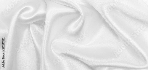 Smooth elegant white silk or satin luxury cloth texture as wedding background. Luxurious background design