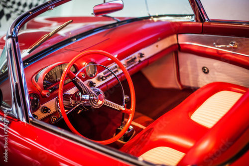 Speedometer and wheel of classic red car cloose-up view from above © Aleksandra