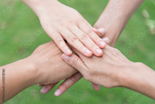 people put their hands together showing teamwork power