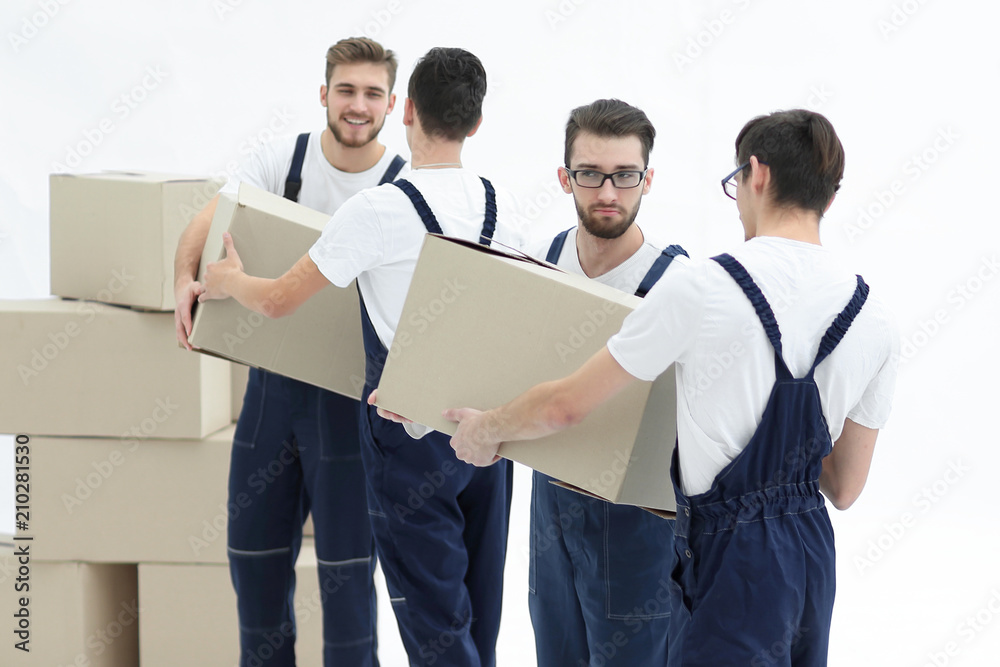 Photo workers pass each other boxes when moving flats. Photo workers pass each other boxes when moving flats.