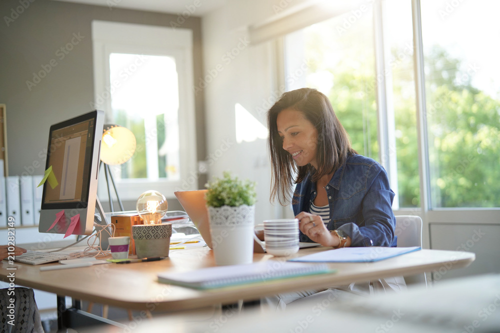Cheerful girl working in co-working office Cheerful girl working in co-working office