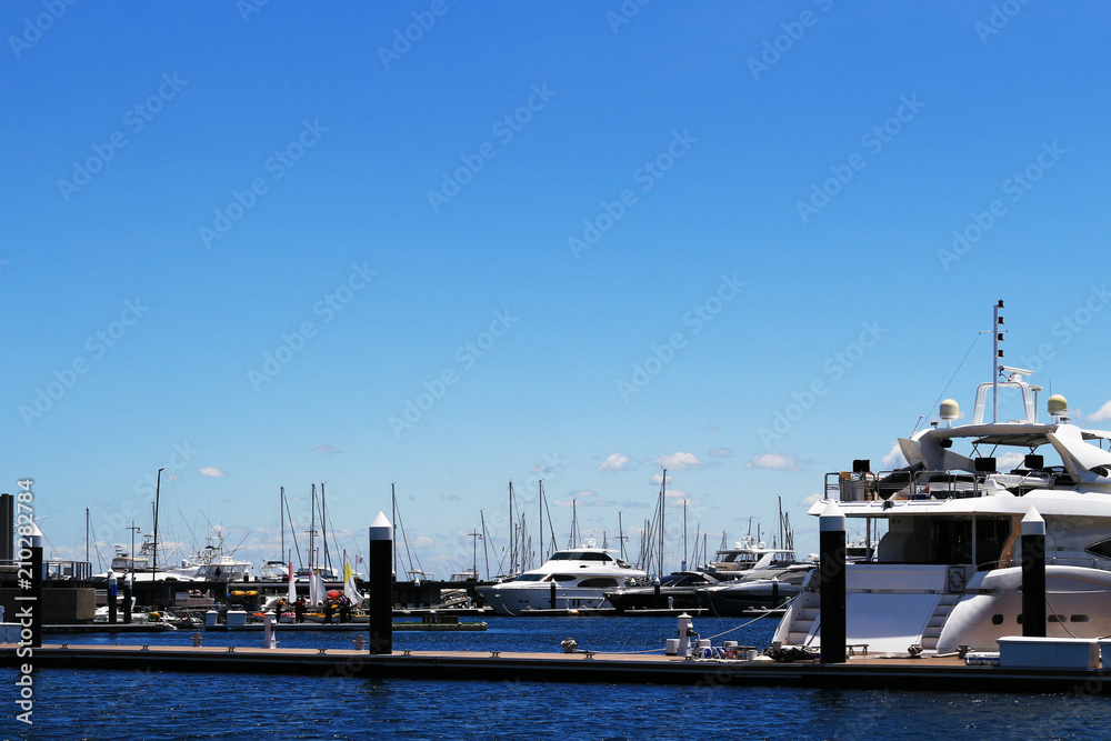 Luxurious summer view of the marina with a stylish cruiser moored