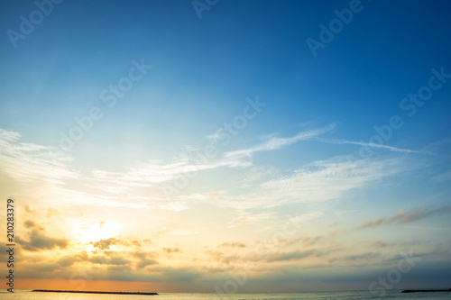 Obraz na płótnie Beautiful early morning sunrise over the sea the horizon,blue sky background texture with white clouds sunset. w salonie