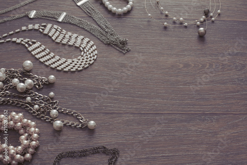 Set of vintage jewelry on a dark wooden background.