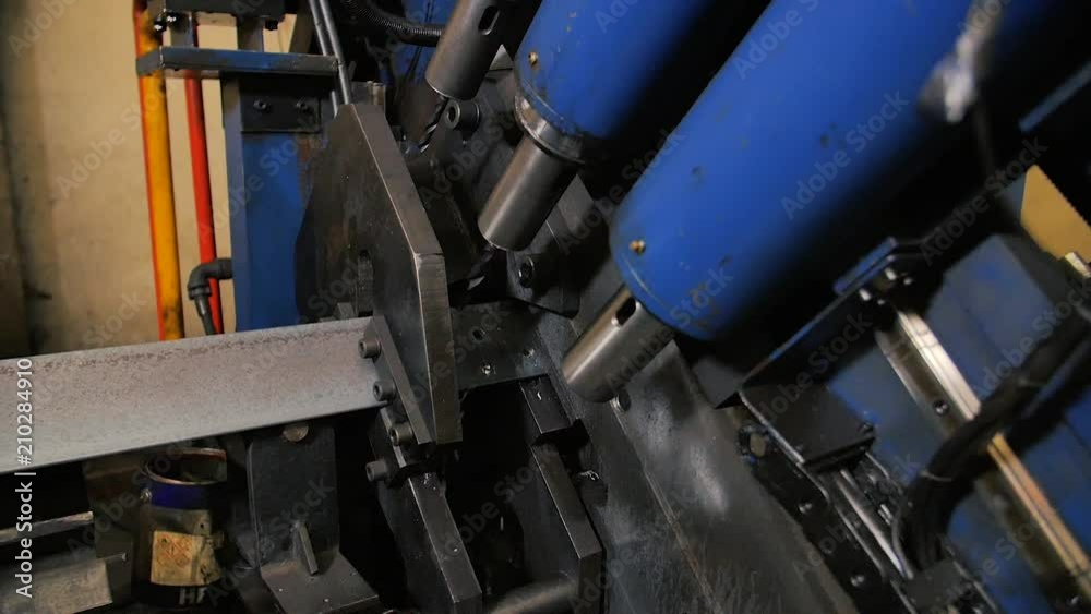 Drilling holes metal iron on industrial CNC machine in factory. Modern technologies.