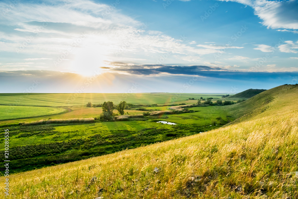 Obraz premium The view from the hill to the fields and lake