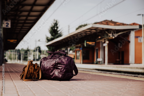 Travel bags of tourist at the platform in railway train station.