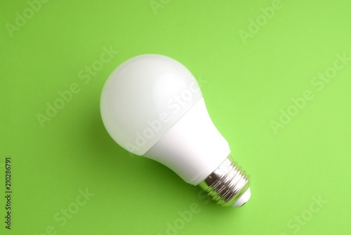White lightbulb on a green background