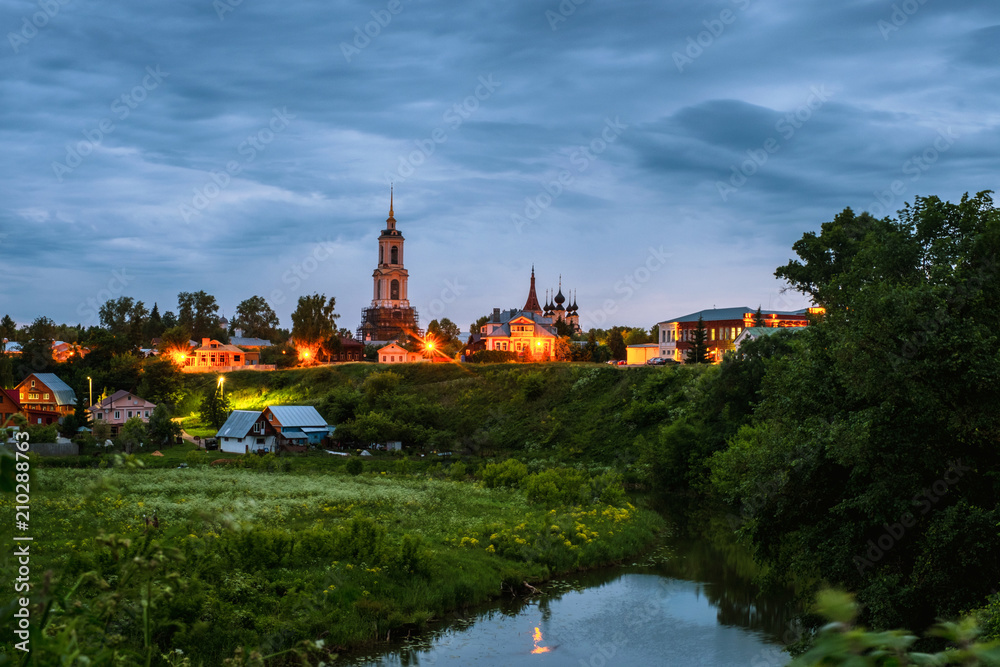 Morning view of old houses and churches in Suzdal, Russia during a cloudy sunrise