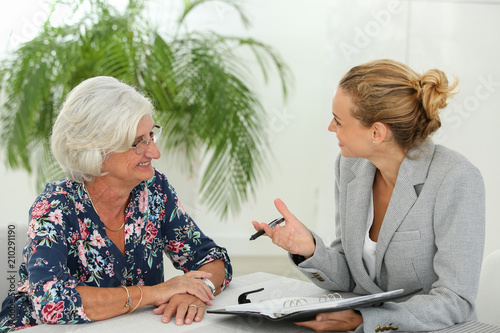 female realtor with retired woman photo