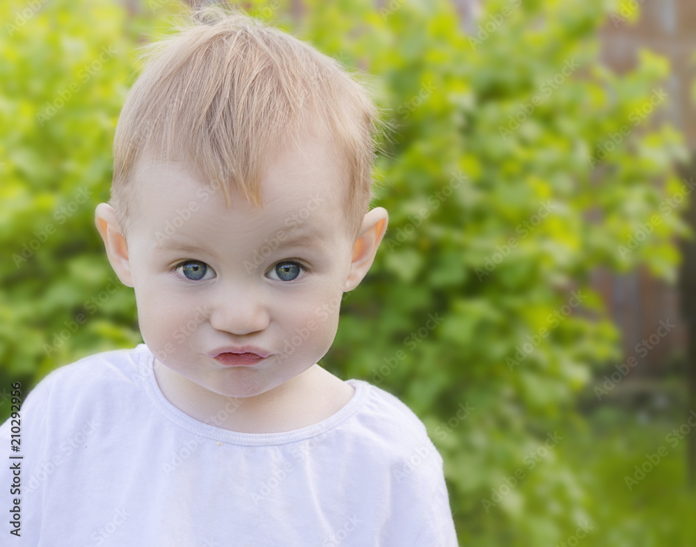portrait of a boy in a white T-shirt on a green background portrait of a boy in a white T-shirt on a green background