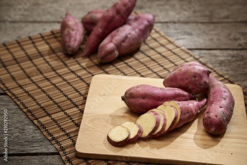 Raw sweet potato on wooden table