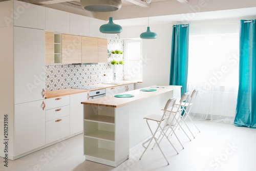 Fototapeta Naklejka Na Ścianę i Meble -  Modern white kitchen cabinets with Induction hob