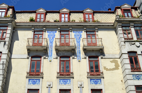 Porto  Portugal. Traditional architecture. Facade with blue tiles and red windows of a stately building. Porto  Portugal. Traditional architecture