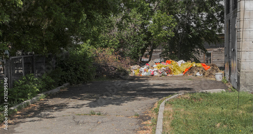 Pile of garbage near the building. Environmental pollution