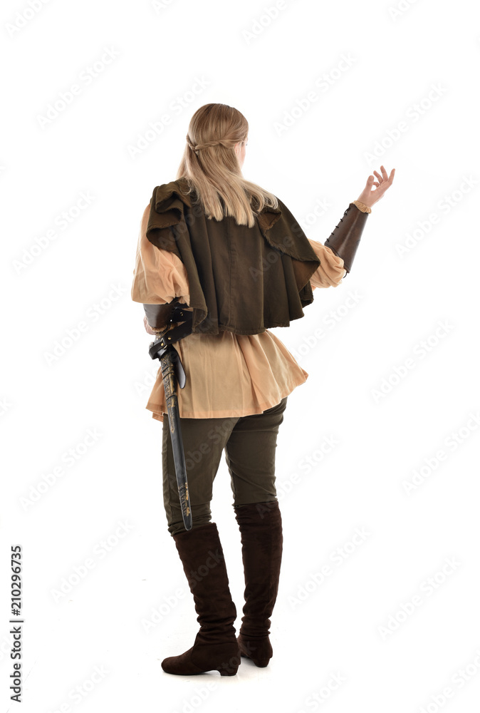 full length portrait of girl wearing medieval costume with sword. standing pose with back to the camera, isolated on white studio background. full length portrait of girl wearing medieval costume with sword. standing pose with back to the camera, isolated on white studio background.