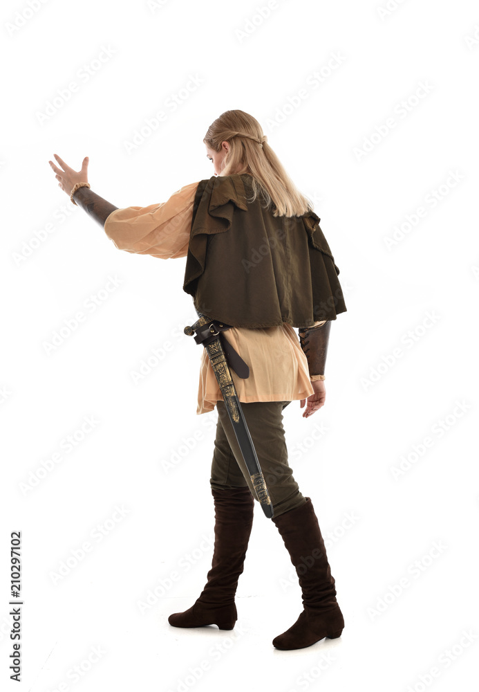 full length portrait of girl wearing medieval costume with sword. standing pose with back to the camera, isolated on white studio background. full length portrait of girl wearing medieval costume with sword. standing pose with back to the camera, isolated on white studio background.