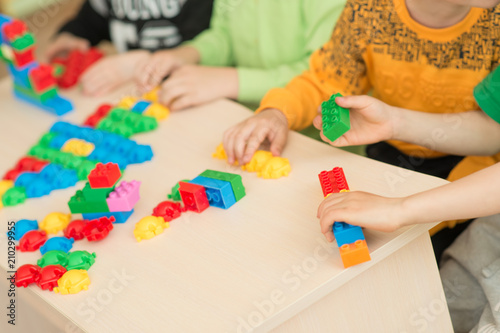 Fotografie kids playing with puzzle, education concept