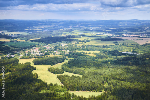 Fototapeta Naklejka Na Ścianę i Meble -  Aerial view of South Bohemian landscape with fields, forests and dramatic sky in Czech Republic.