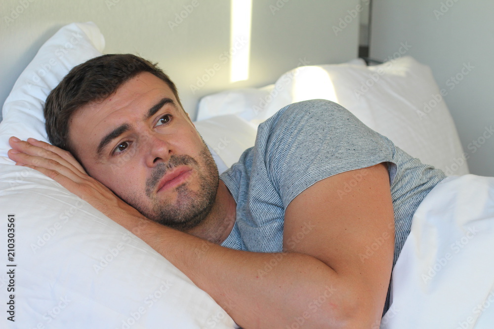 Man with sad expression in bed Man with sad expression in bed
