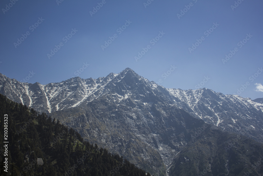 mountain valley with snow peak and blue sky