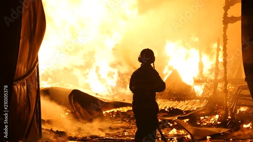 Firefighter In Front Of A Open Fire