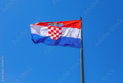 Flag of Croatia waving in the wind against the sky photo