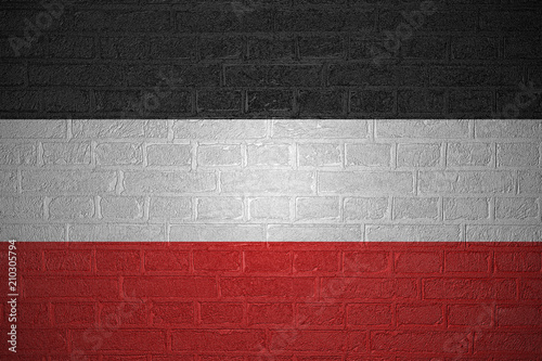 Flag of the German Empire on brick wall background, 3d illustration